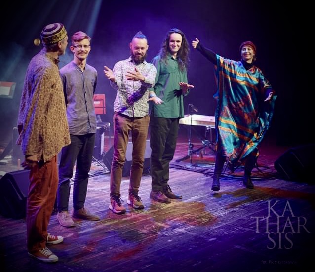 Muzycy na scenie podczas występu artystycznego.