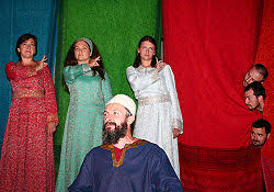 Grupa osób w tradycyjnych strojach teatralnych.